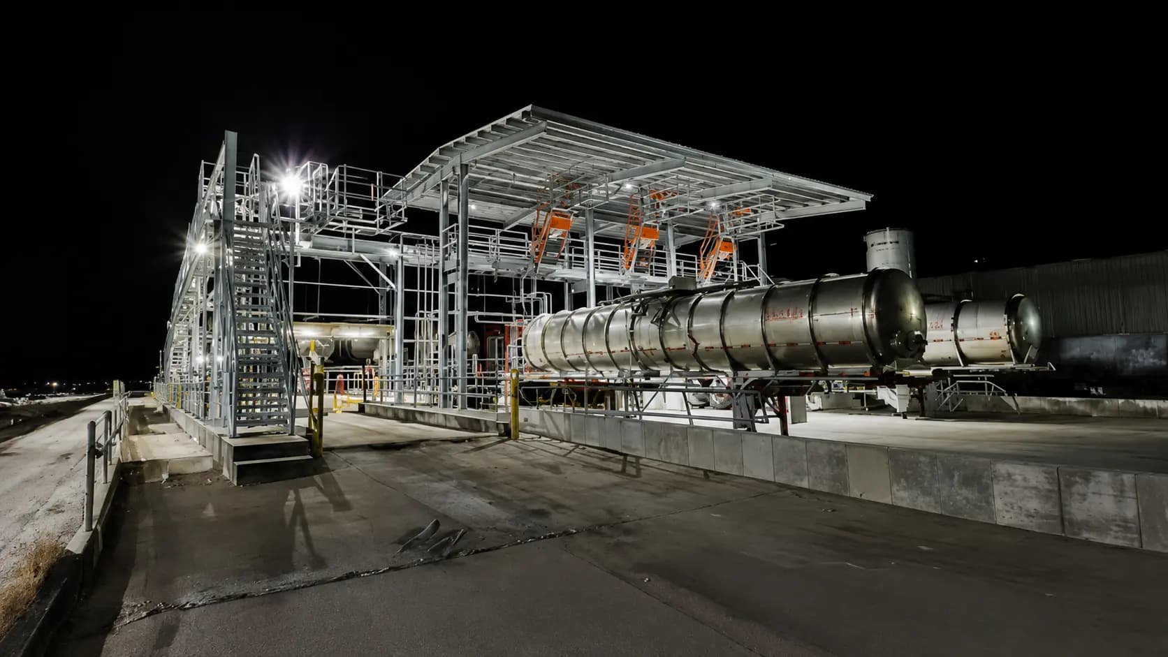 Steel pipe rack and process structures at an energy facility at night
