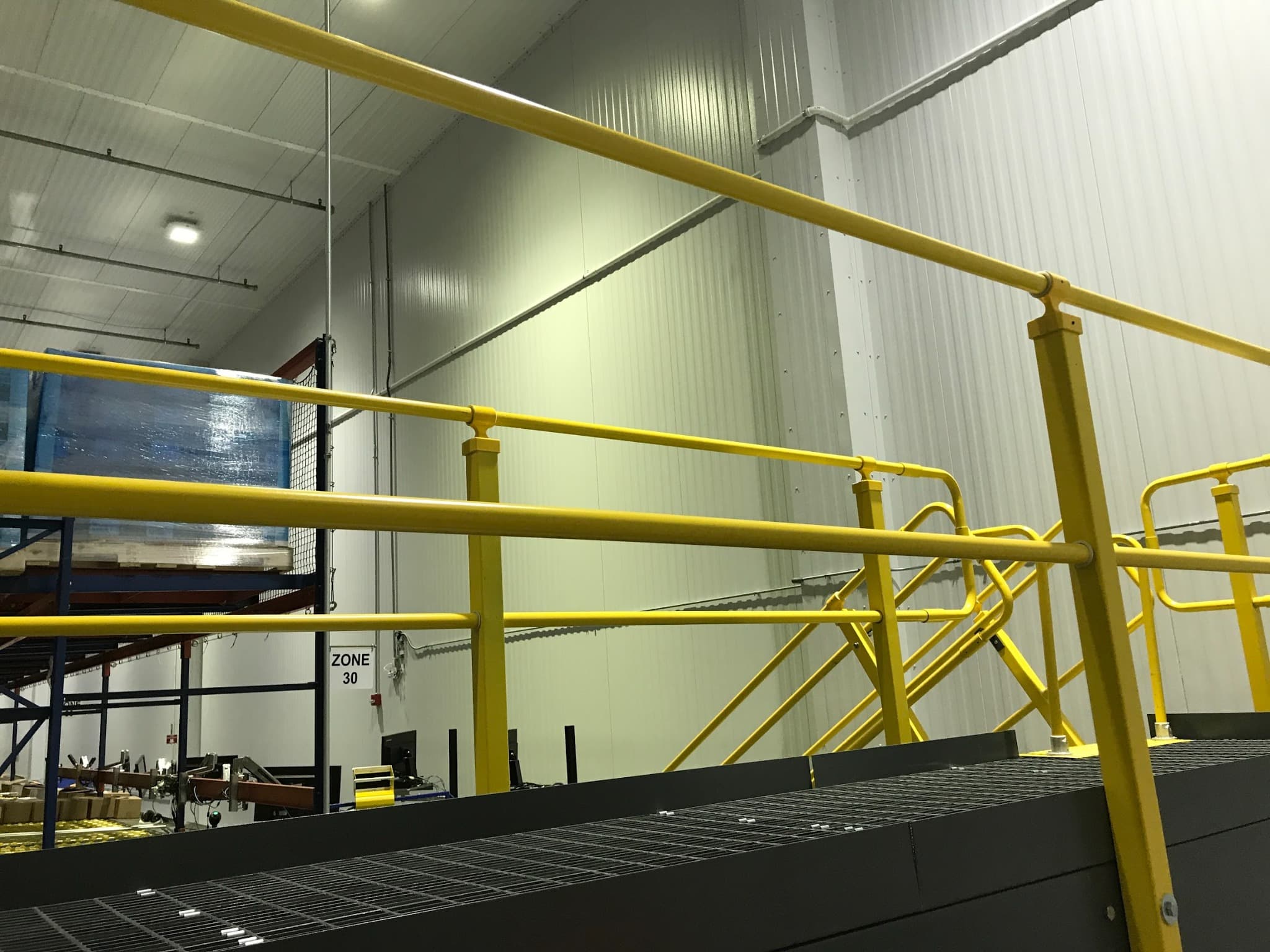 Yellow safety handrail and platform in a facility