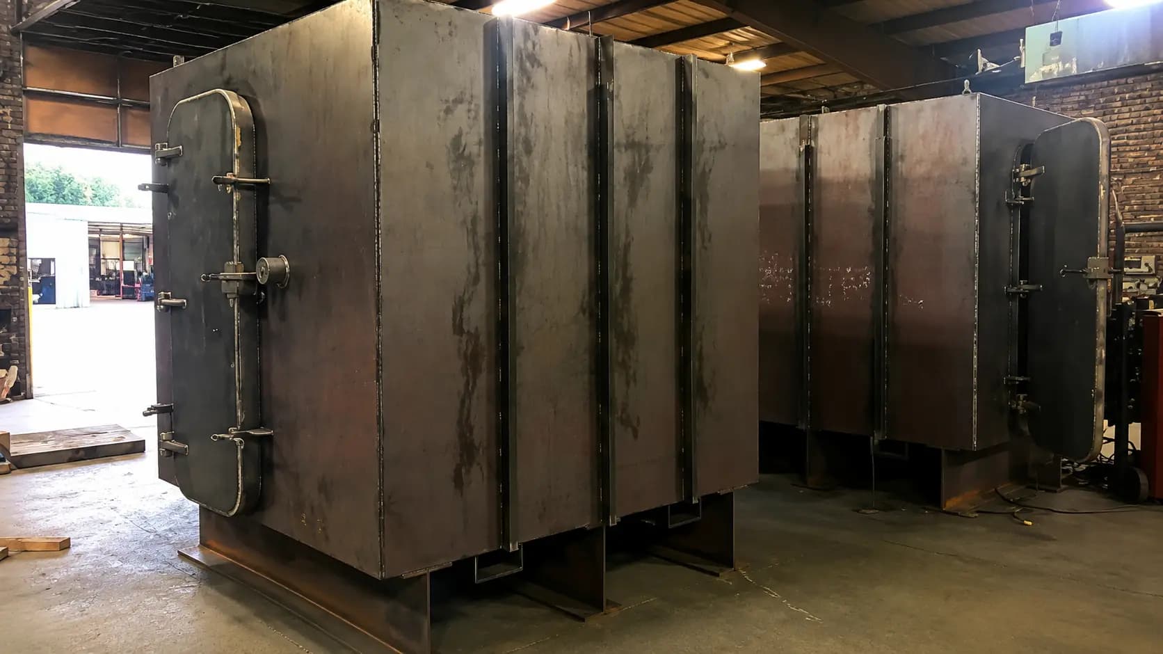Large fabricated steel equipment enclosure in the shop