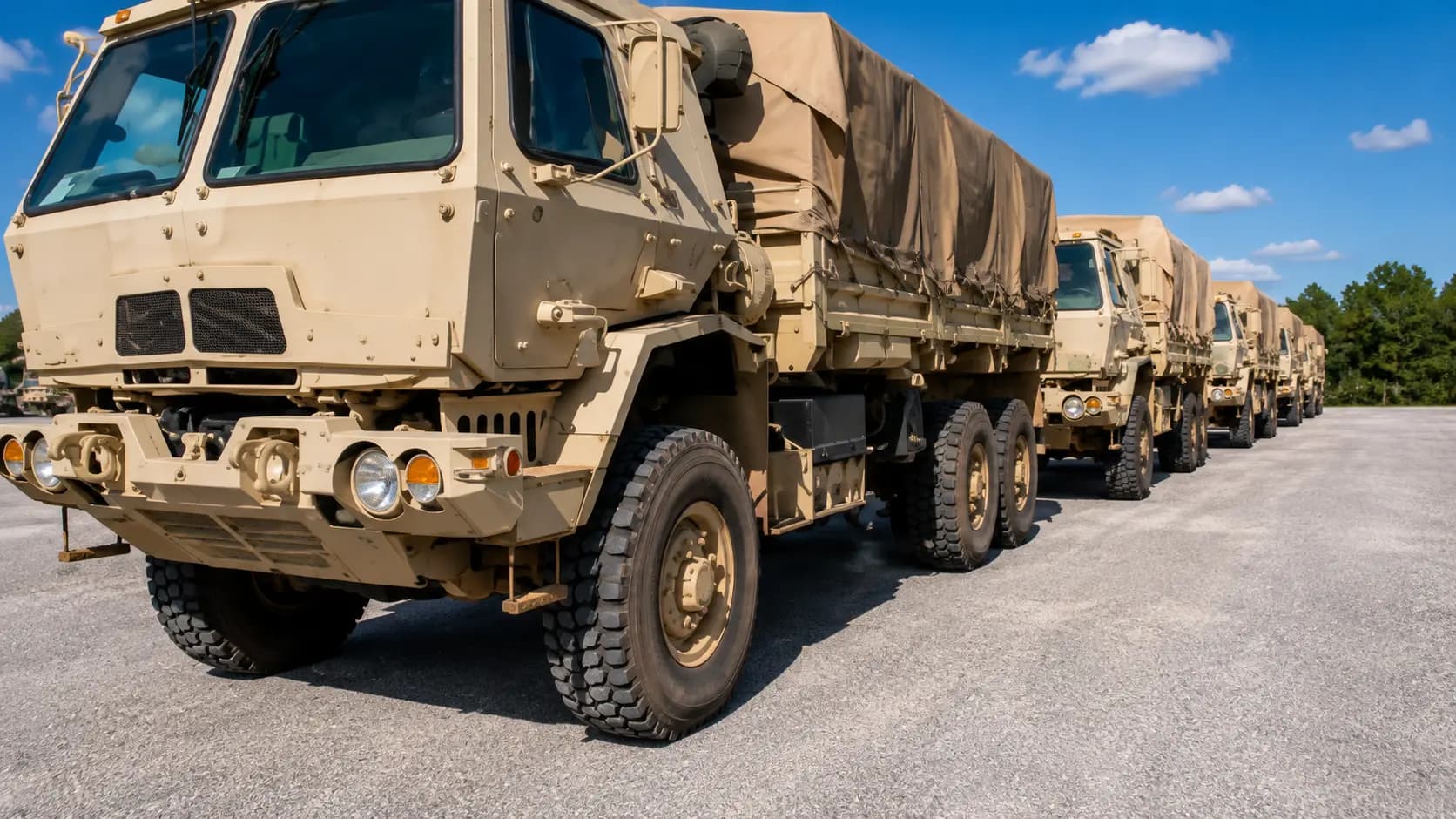 Row of military tactical transport vehicles