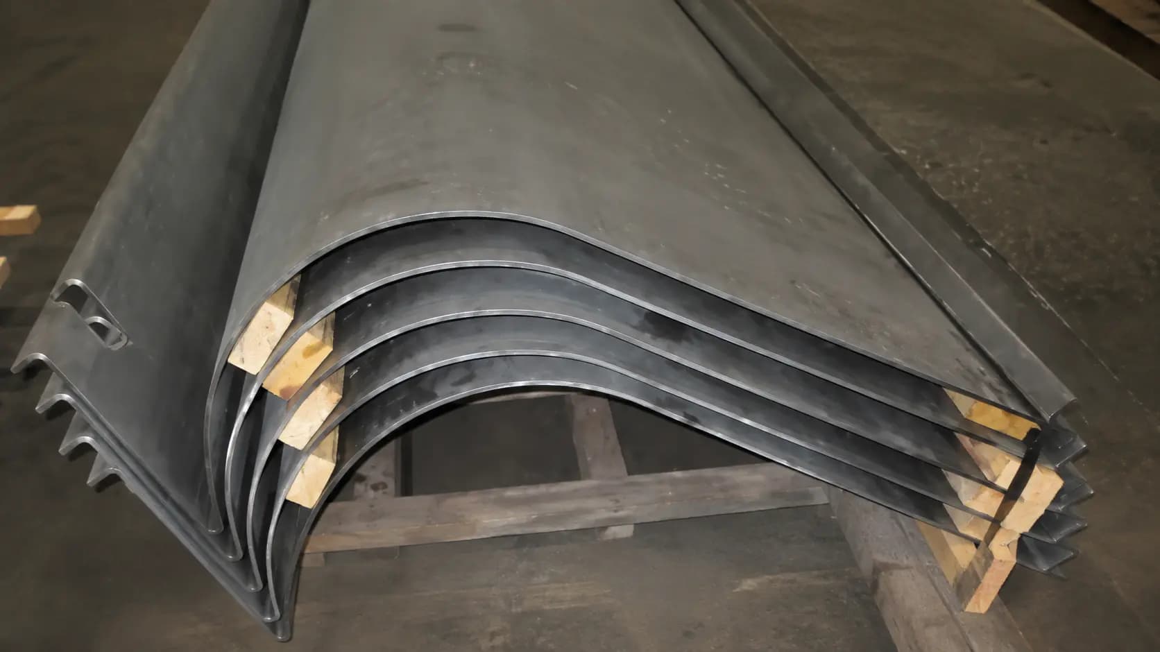 Curved formed steel plate segments on the shop floor