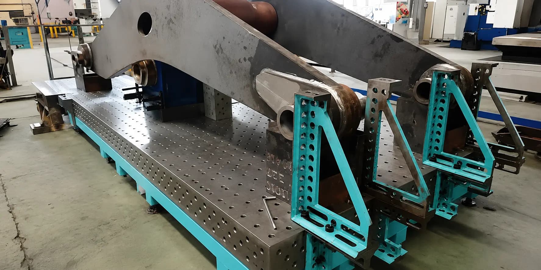 Fabricated steel welding fixture table with agricultural equipment components