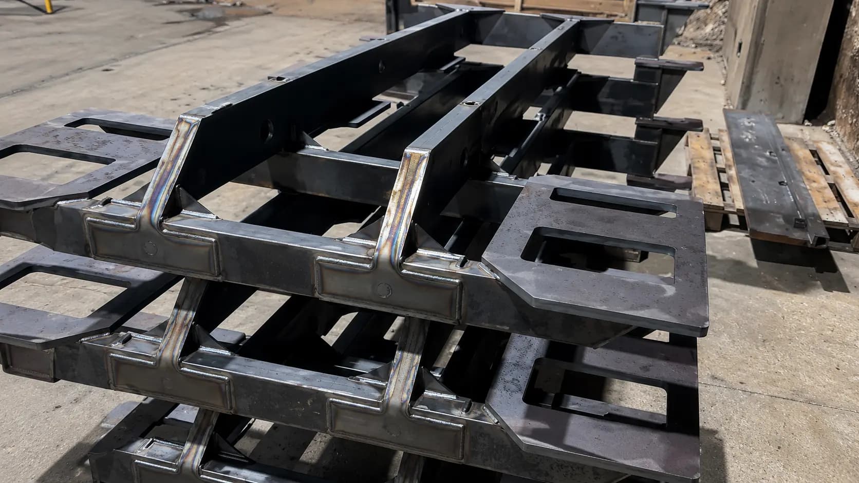 Heavy steel weldment fixtures on the shop floor
