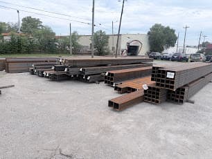 Staged steel tube stock and fabricated components in the yard