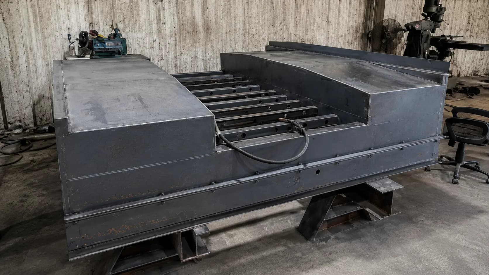 Large fabricated steel pan weldment on the shop floor