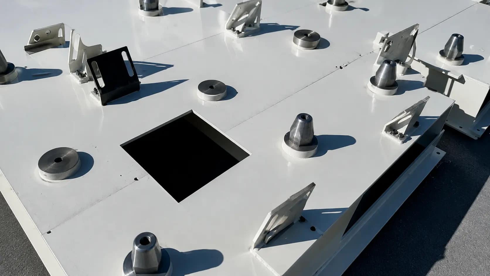 Precision-machined steel plate with bored holes and mounting bosses