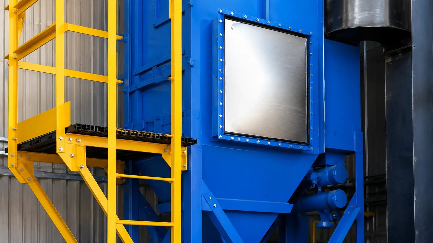 Yellow access platform and stair with a blue equipment enclosure