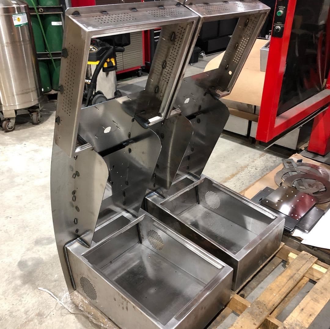 Fabricated stainless steel brackets and panels staged in the shop