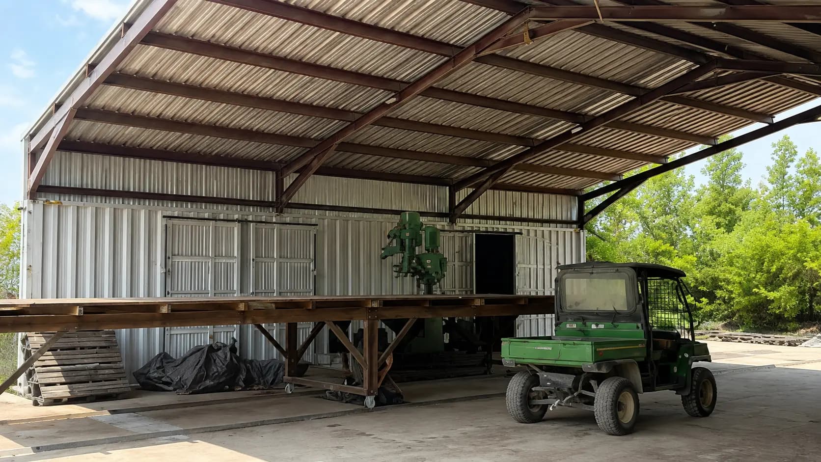 Fabricated steel canopy structure with a utility vehicle underneath