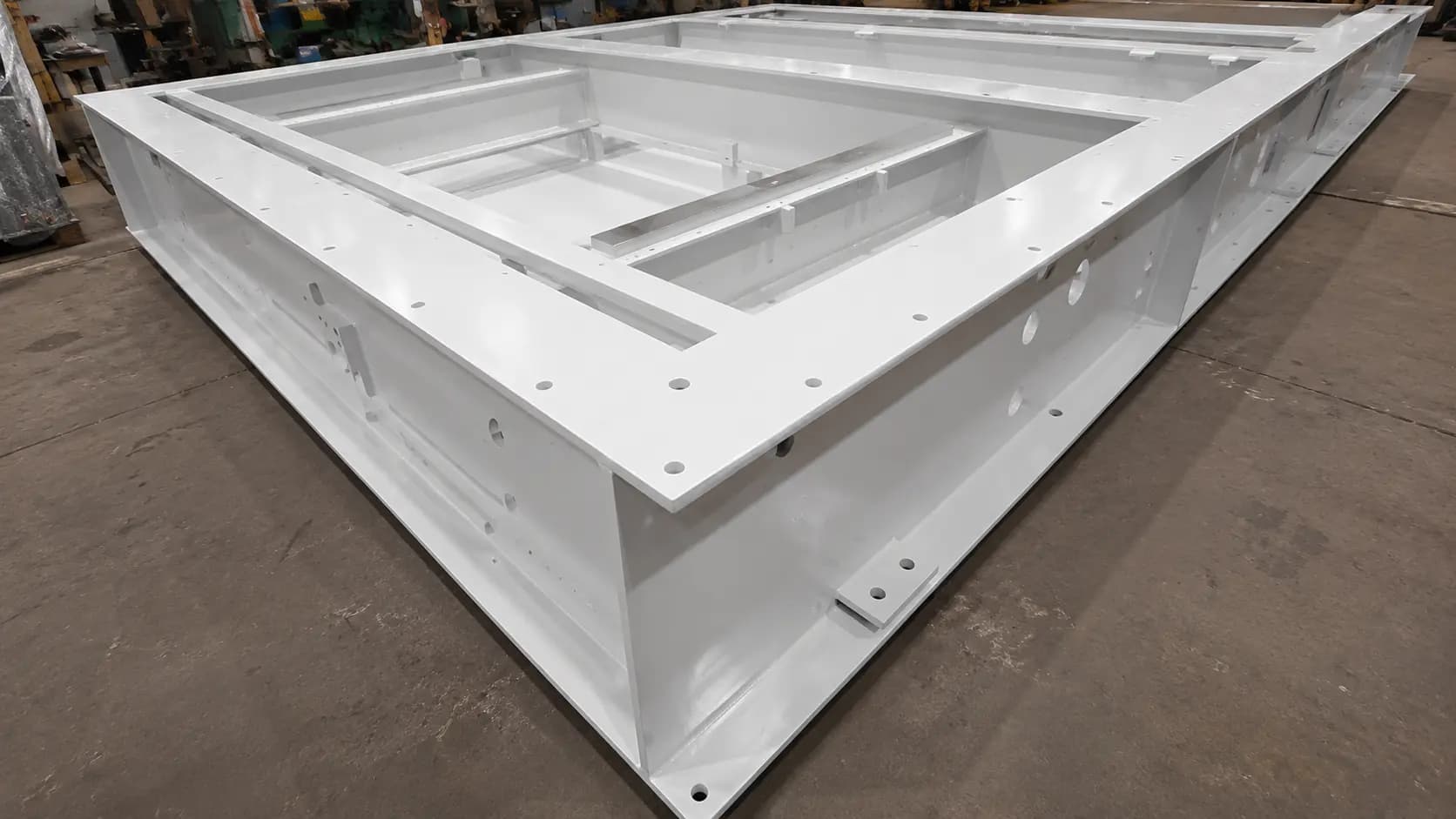 Large white-painted triangular fabricated steel frame