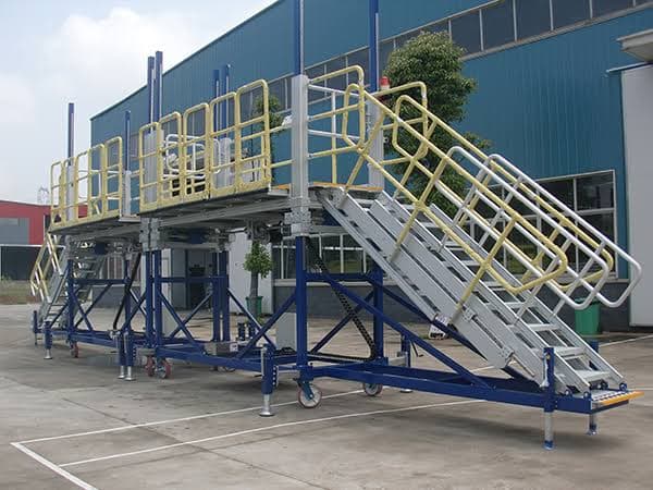 Steel access platform with stairs and yellow handrail