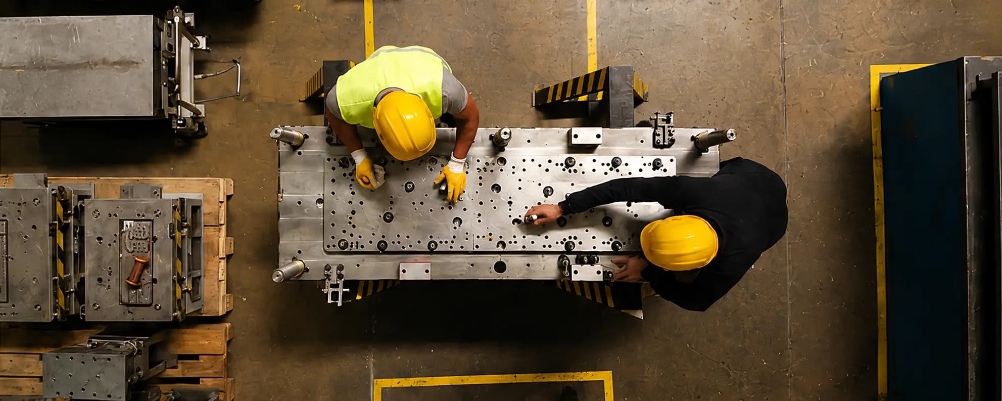 Schuler team members working together on a large steel fixture