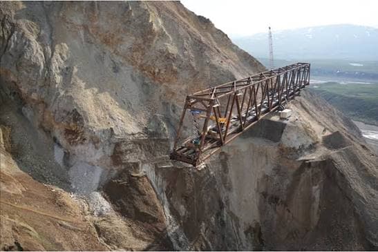 Steel truss cantilevered over the active slide at Polychrome Pass