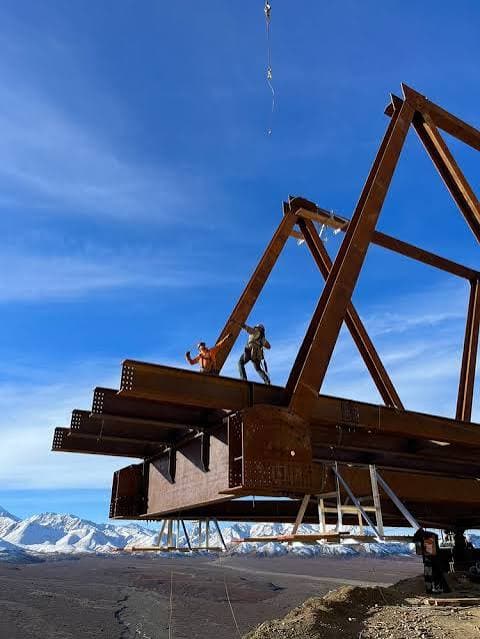 Truss erection with crew working on fabricated steel members