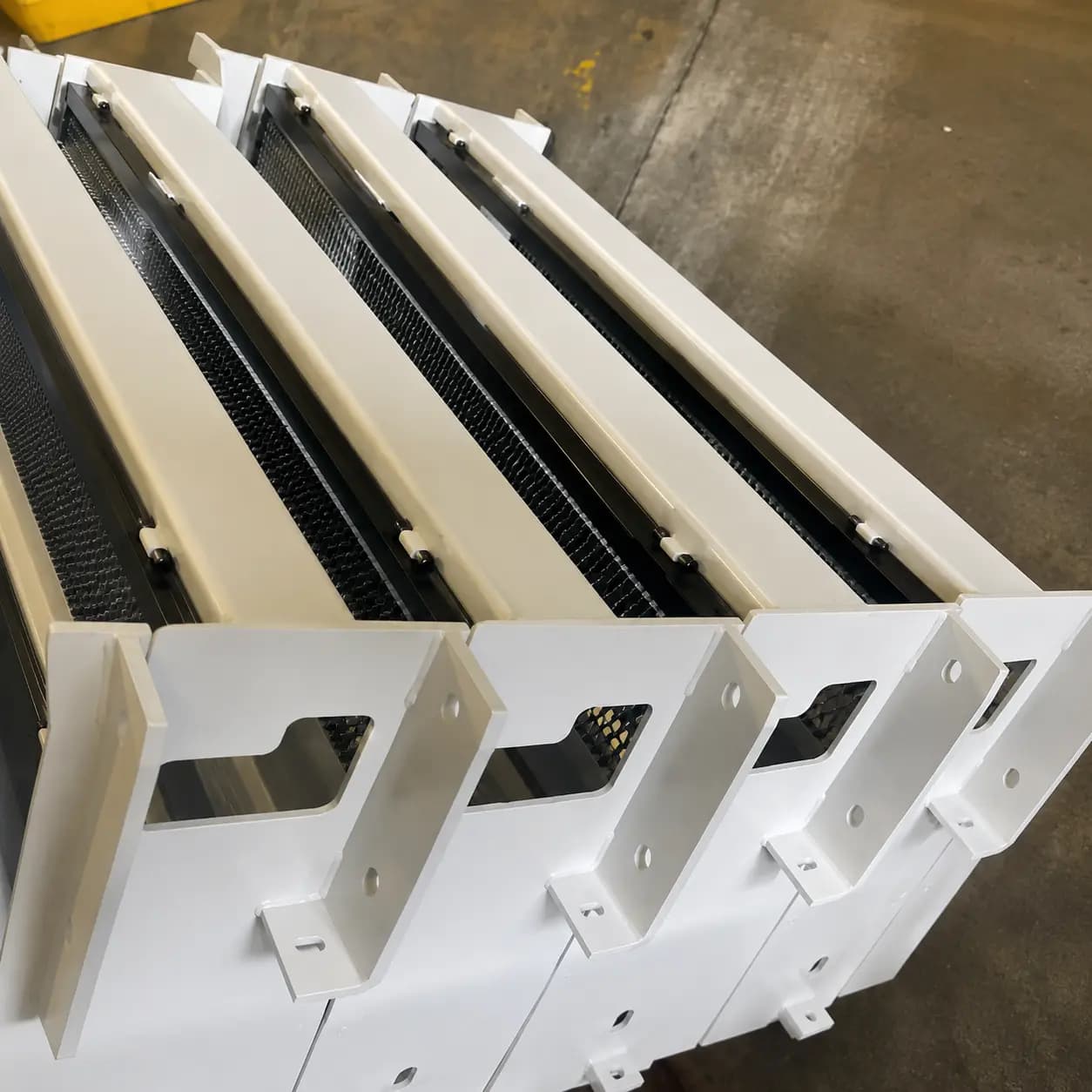 Fabricated steel conveyor support assemblies staged for coating