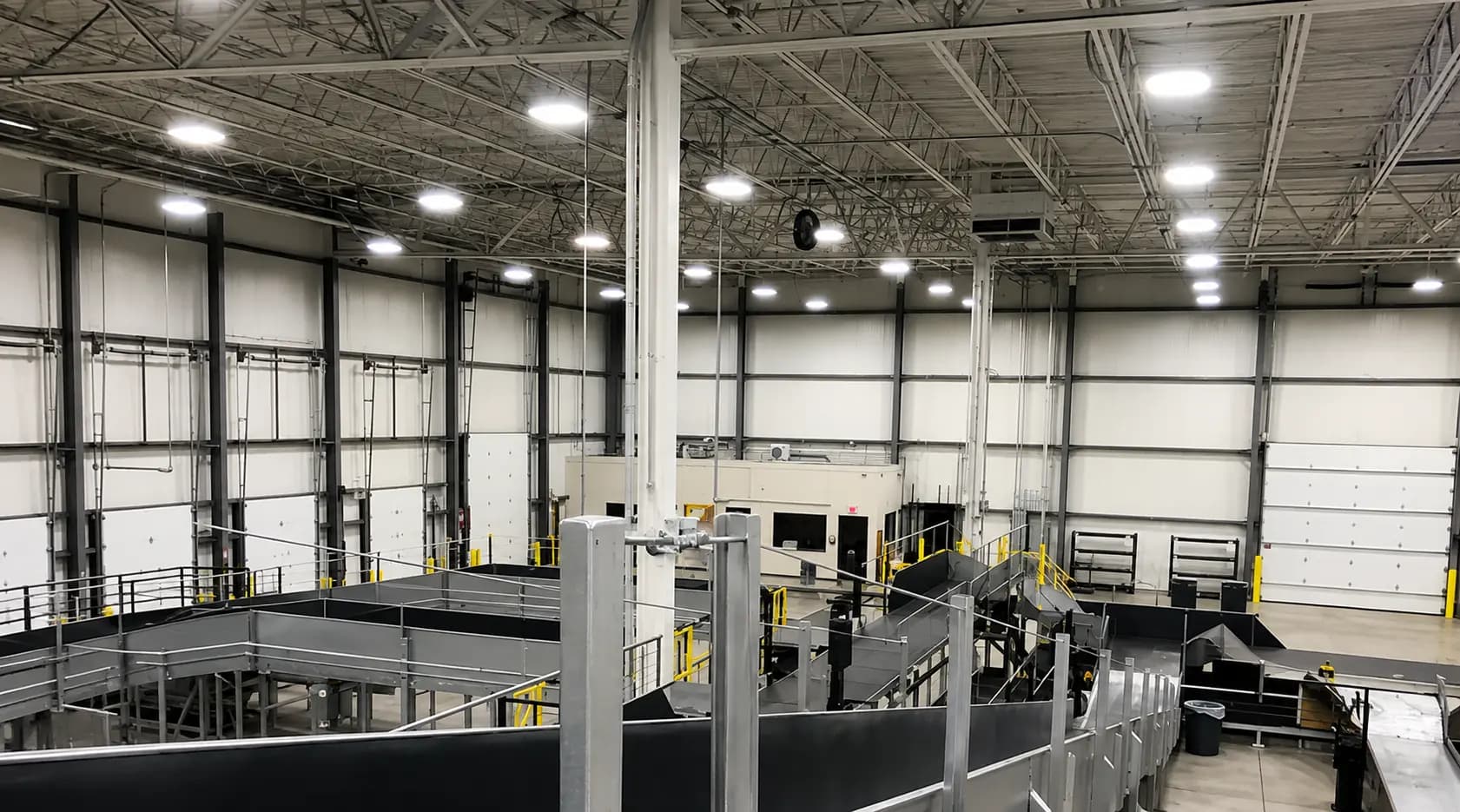 Interior of a distribution facility with fabricated steel platforms and conveyors