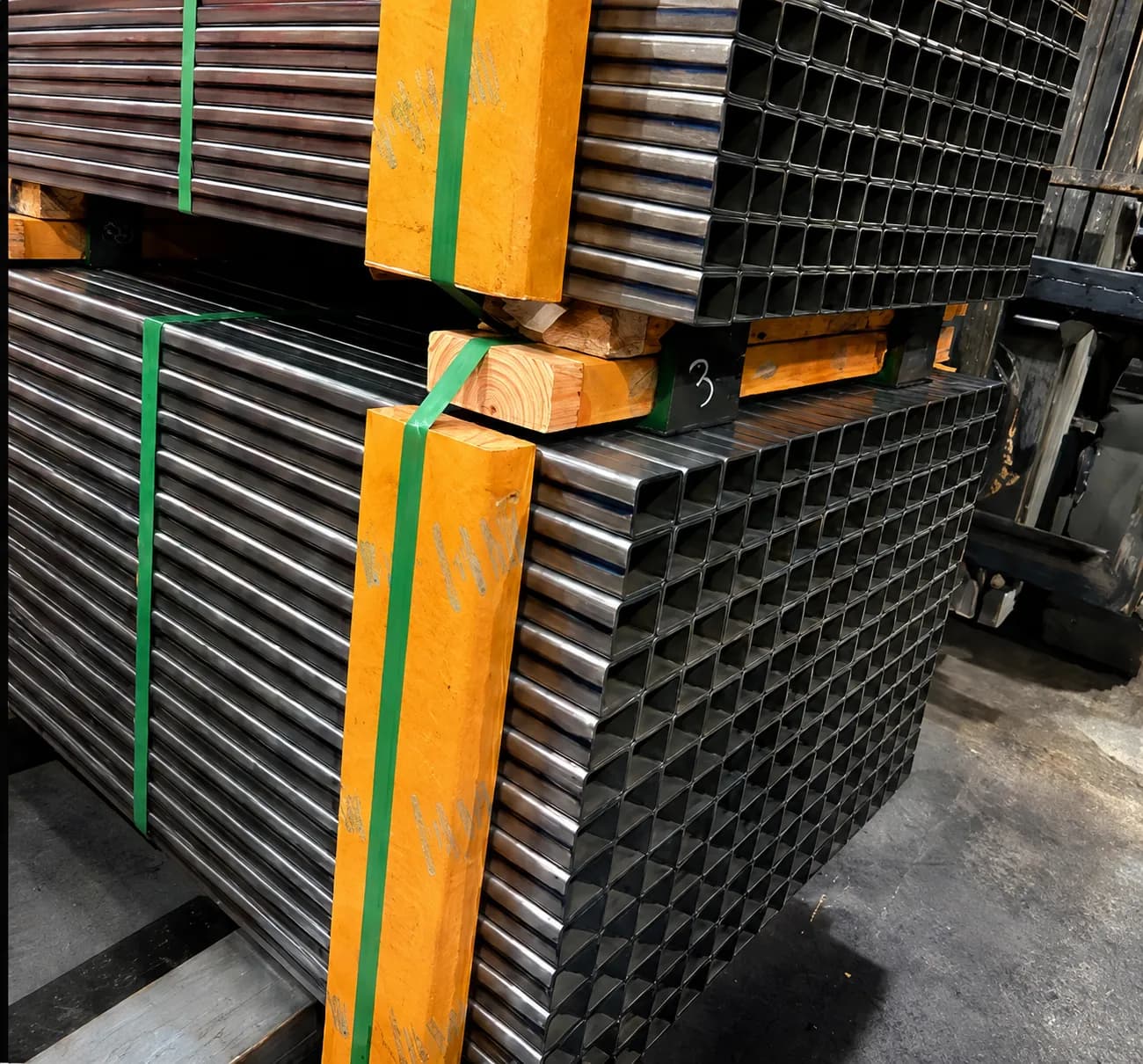 Bundles of square and rectangular steel tube stacked in the shop