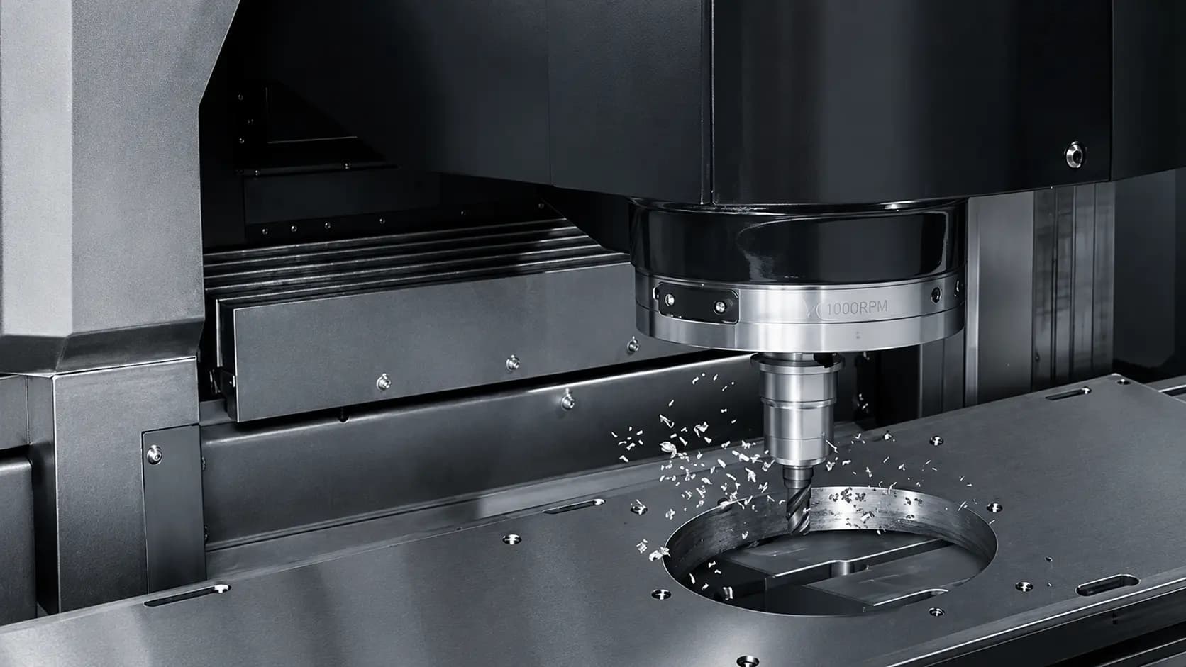 CNC machining center cutting a steel component